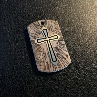 Cross Pendant in stainless steel overhead shot natural light