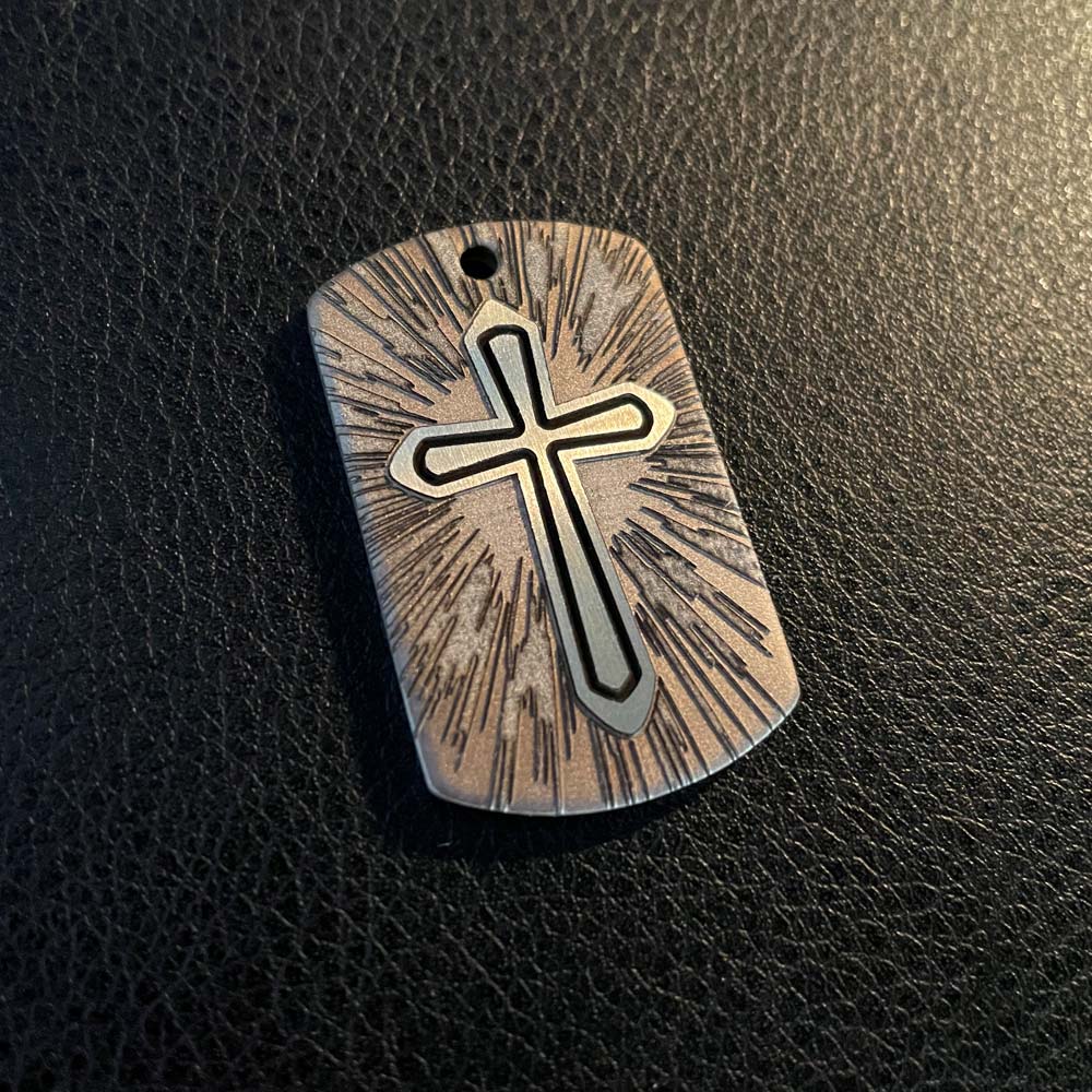 Cross Pendant in stainless steel overhead shot natural light