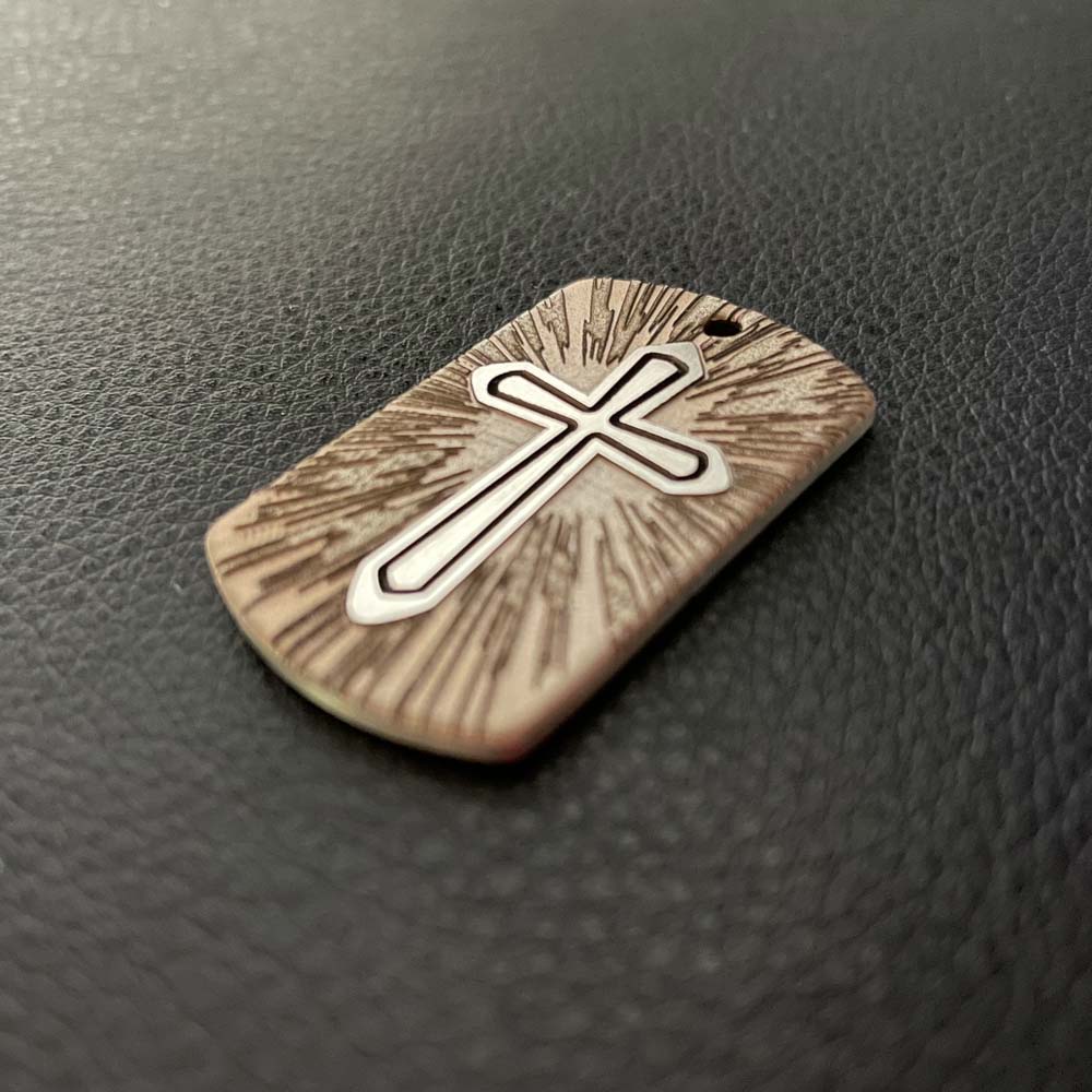 Cross Pendant in stainless steel perspective shot natural light
